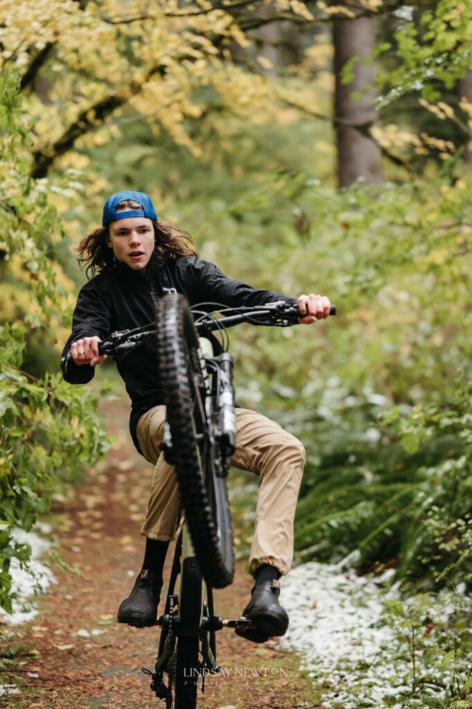 senior guy riding his mountain bike during his senior photography experience