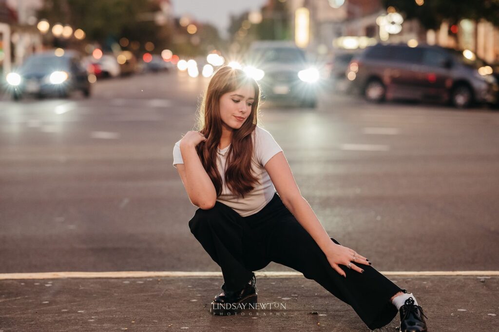 senior girl posing in front of traffic