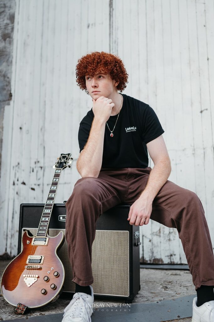 senior guy posing with his guitar during his senior photography experience