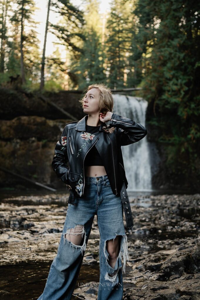 senior girl posing in front of waterfall
