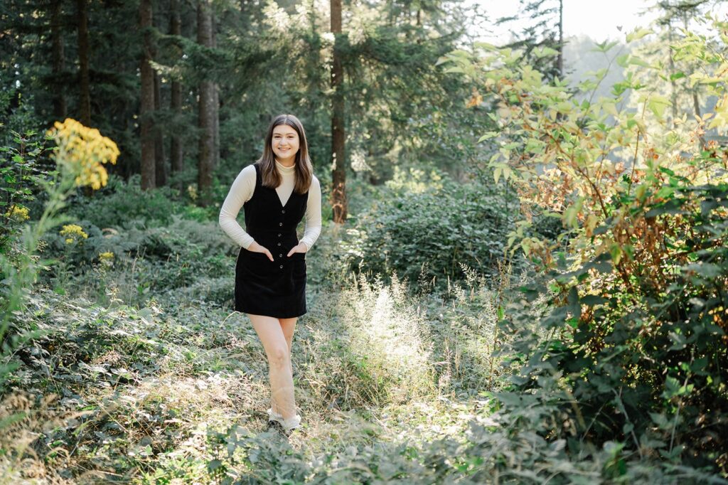 Senior girl standing in the forest at one of my favorite senior photo locations