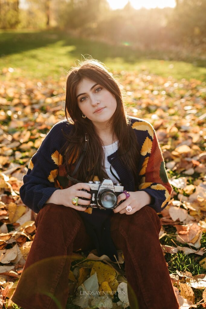 fall senior girl sitting in leaves