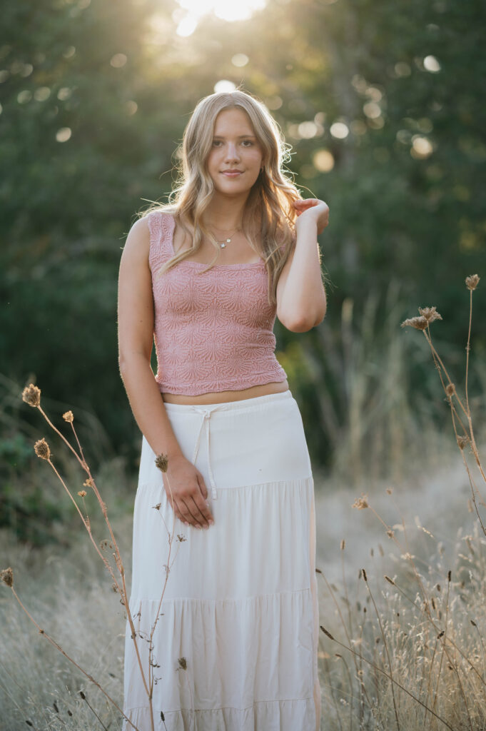 high school senior in a grass field at Basket Slough.