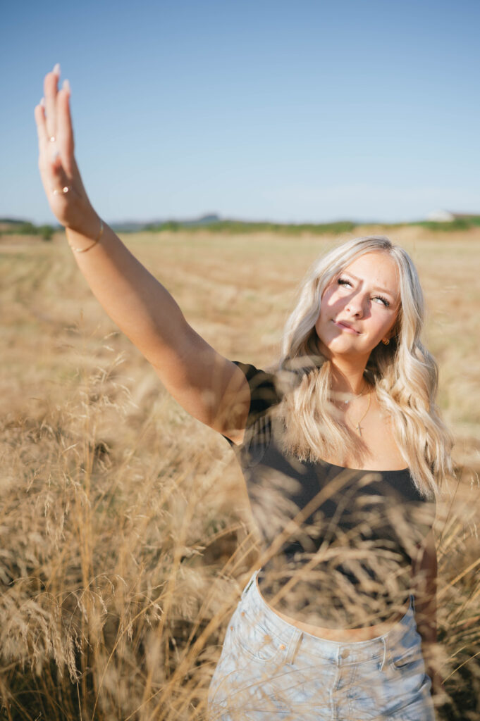 high school senior in a grass field at Basket Slough.