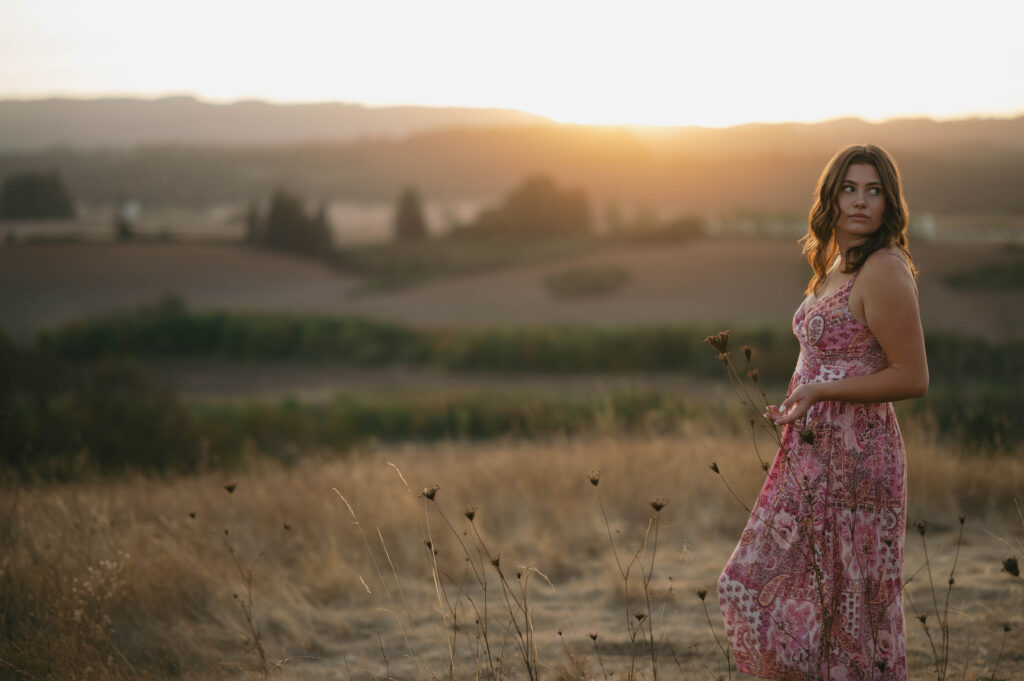 high school senior in a grass field at Basket Slough.