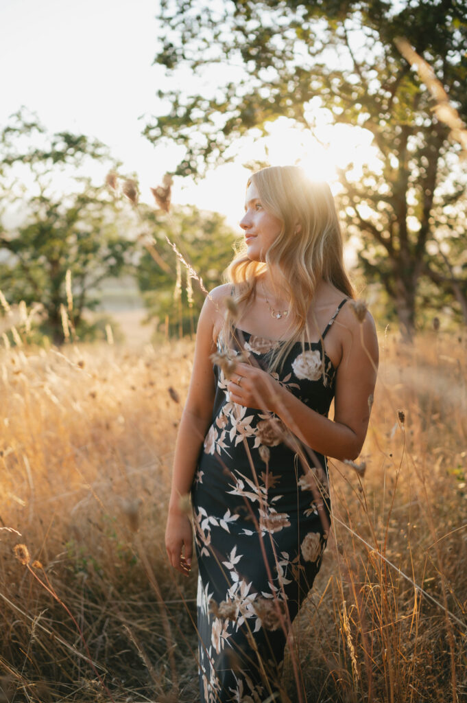 high school senior in a grass field at Basket Slough.