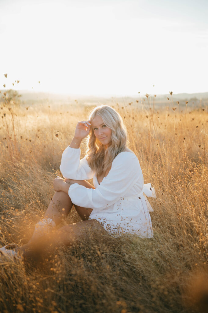 high school senior in a grass field at Basket Slough.