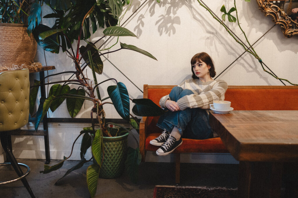 Cozy sweater senior portraits at coffee shop in downtown Salem Oregon